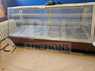 Commercial display case with two wire shelves, glass front, and wood base. Good condition. Tag number 33 visible on top.