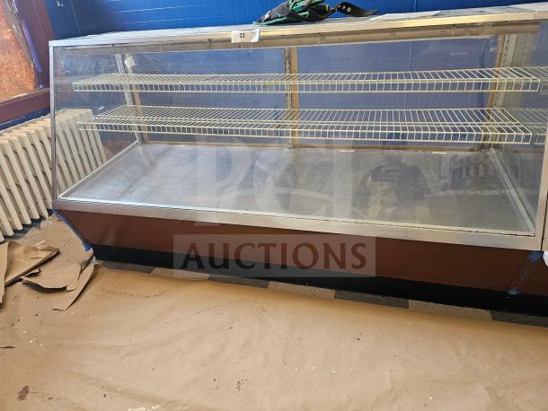 Commercial display case with two wire shelves, glass front, metal base, and numbered tag. Used, fair condition.