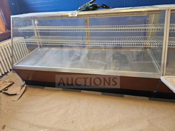 Commercial display case with glass front and three wire shelves, metal frame, moderate wear. Auction tag number 33 visible.