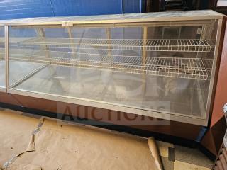 Commercial display case with glass front, metal shelves, and wooden base. Tag labeled "34". Used condition.