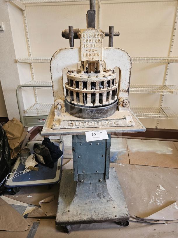 Dutchess Tool Company dough divider, vintage, metal construction, "Fishkill on Hudson" marking, signs of wear, sturdy base.