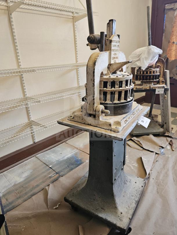 Vintage Dutchess Tool Company dough divider, cast iron, manual lever, visible wear, embossed logo, industrial kitchen tool.