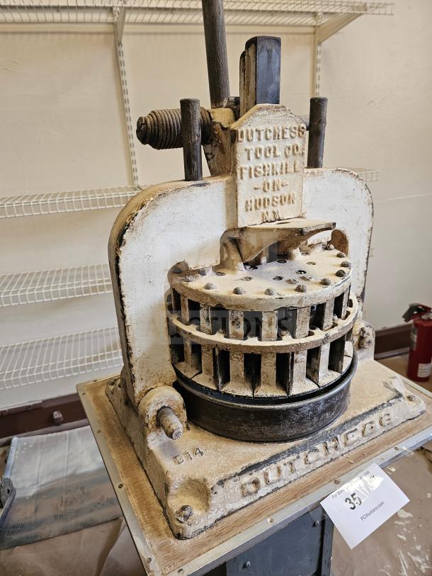 Antique Dutchess Tool Company dough divider, metal construction, Fishkill-on-Hudson label, in used condition.