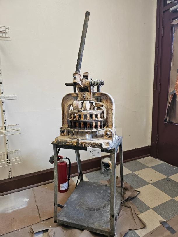 Dutchess Tool Company dough divider, manual lever, metal body, aged condition, on metal stand, model number not visible.