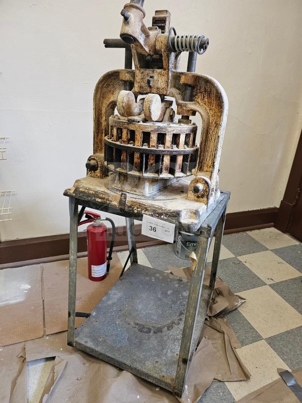 Vintage Dutchess Tool Company dough divider, metal construction, rustic condition, with number 36 tag displayed.