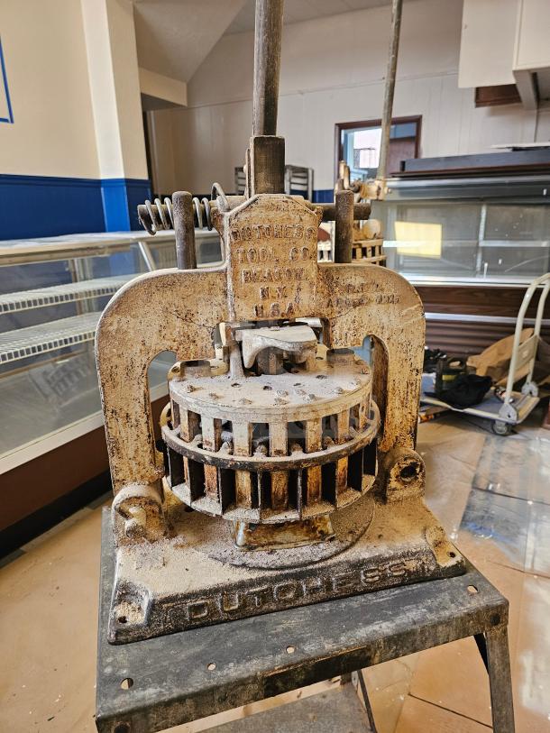 Dutchess Tool Company dough divider, cast iron, vintage condition, visible wear, embossed branding, industrial use.