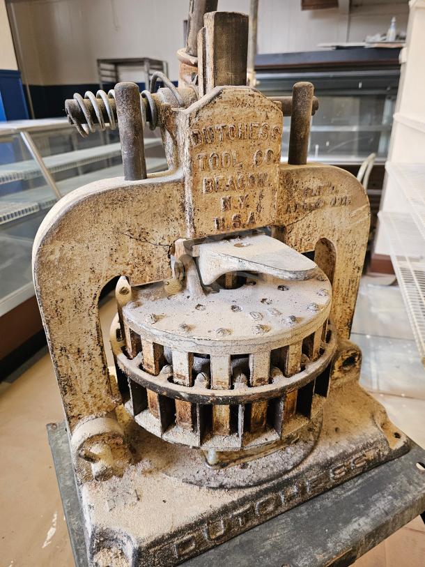 Antique Dutchess Tool Company dough divider, vintage, heavy-duty metal, Beacon, NY, USA. Rustic condition with visible wear.