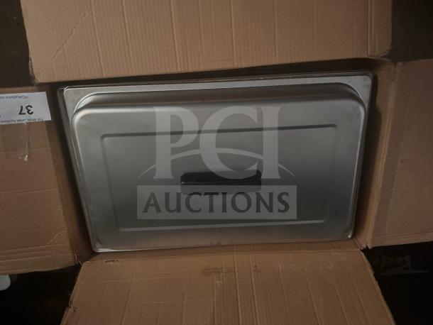 Full-size stainless steel chafer in box, new condition, with black handle. Auction tag visible, marked with number 37.