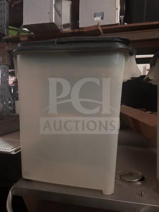 Translucent storage food container with a black lid, in good condition. Ideal for bulk storage. No visible labels.