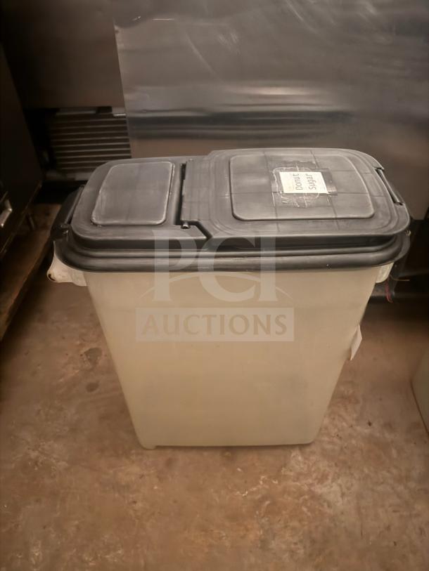 Plastic storage food container with a black lid, labeled for sugar. Slightly worn, suitable for kitchen storage.