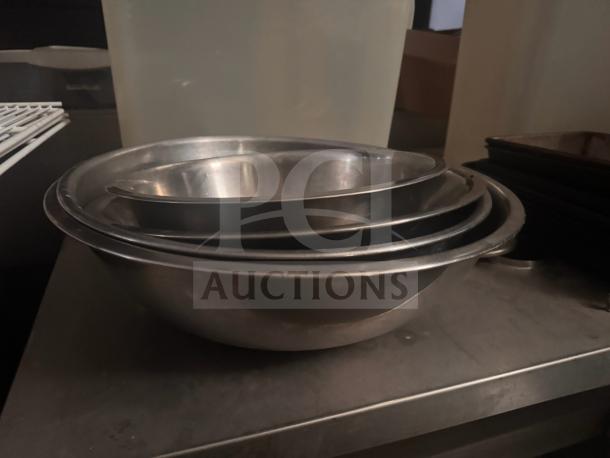 Stainless steel mixing bowls, nested set, gently used. Durable, ideal for kitchen tasks. No visible tags or markings.