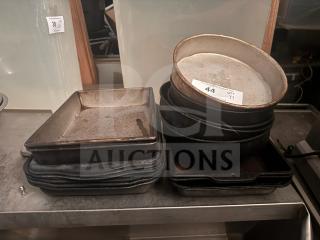 Lot of 17 miscellaneous baking pans, assorted shapes and sizes, visible wear, includes square and round pans, tagged for auction.