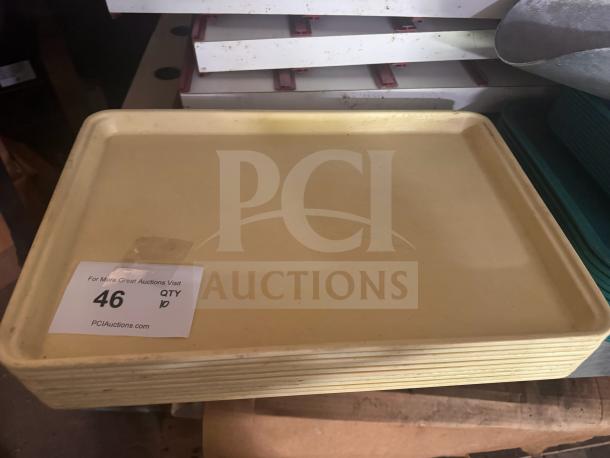 Lot of 10 yellow plastic trays, stacked, minor wear; auction label "46, QTY 10" visible.