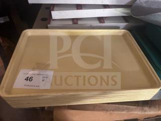 Lot of 10 yellow plastic trays, stacked, minor wear; auction label "46, QTY 10" visible.