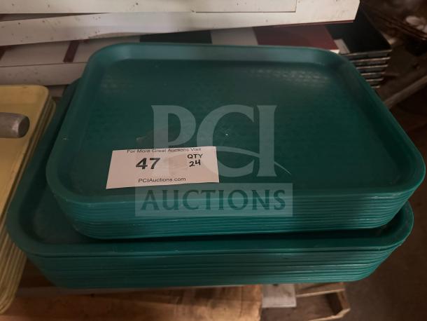 Green plastic food tray stack, lightly used, with quantity label showing "47 QTY 24."