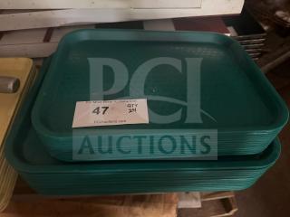 Green plastic food tray stack, lightly used, with quantity label showing "47 QTY 24."
