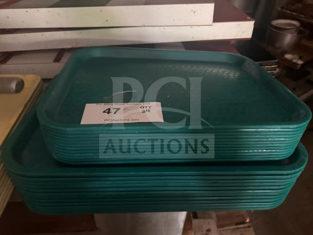 Stack of green plastic food trays in good condition, rectangular shape. Label indicates quantity 24, item number 47.