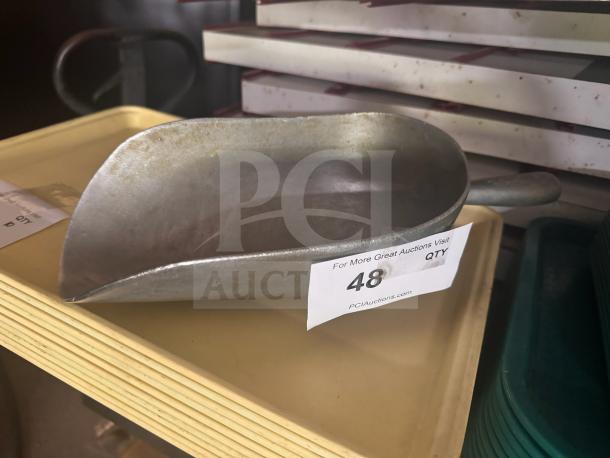 Metal scoop with handle, marked with auction tag number 48. Appears in used condition, suitable for scooping grains or ice.