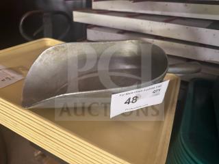 Metal scoop with handle, marked with auction tag number 48. Appears in used condition, suitable for scooping grains or ice.