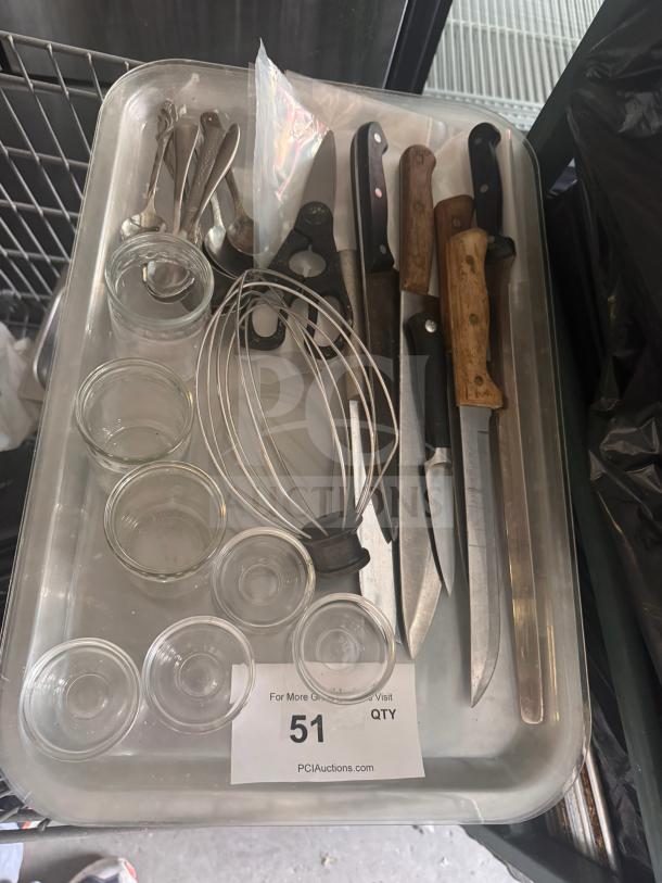 Assorted kitchenware including knives, utensils, glass bowls, and a whisk on a tray. Condition varies. Auction lot #51.