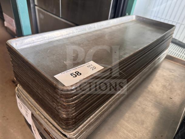 1/2 size long bakery display tray, metal, stack of 8, used condition, auction tag labeled "58 QTY 29" visible.