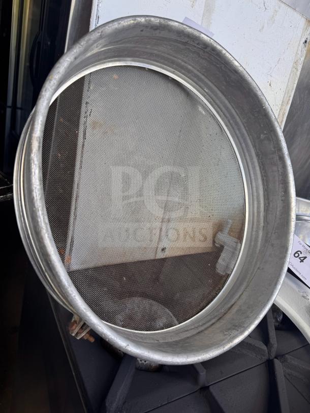 Aluminum flour sifter with fine mesh screen, in used condition. Features a sturdy rim and visible wear, ideal for baking.