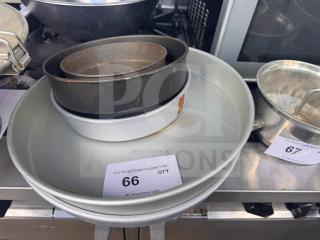 Lot of 5 miscellaneous baking pans; various sizes, some wear, steel construction. Auction tag "66 QTY" visible.