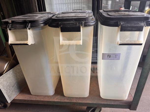 Three large storage food containers with black lids, used condition. Label indicates quantity of 3.