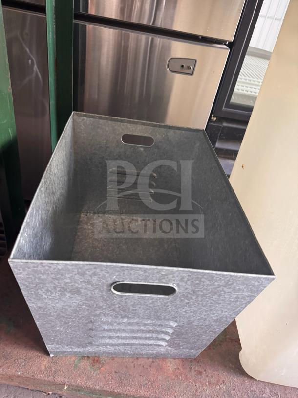Steel galvanized utility bin with handle openings and a ribbed design, in excellent condition, suitable for various storage needs.