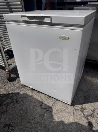 Holiday white chest freezer, solid condition, visible logo on front. Ideal for extra storage. Slight wear on exterior.