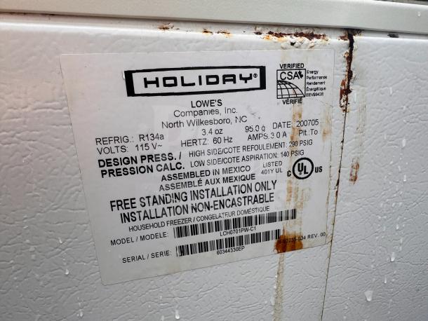 Holiday white chest freezer label showing specifications and rust marks. Model LCH0701PW-C1, 115V, 60Hz, R134a refrigerant. Rust indicates wear.