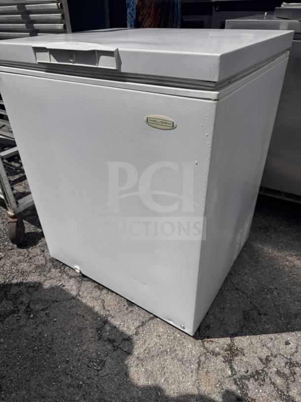 Holiday white chest freezer, minor surface scratches, sturdy build, visible Holiday logo, suitable for large storage needs.