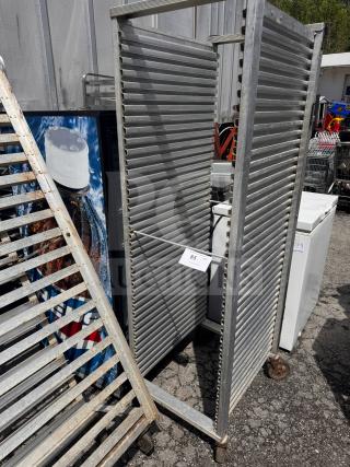 Industrial sheet pan rack on wheels, sturdy metal construction, multiple slots, used condition, auction tag "85".