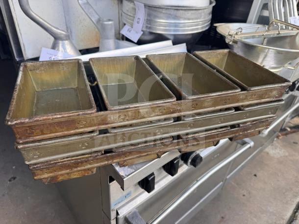 Lot of 3 industrial baking pans, stacked, showing welded joints, used condition with visible wear.