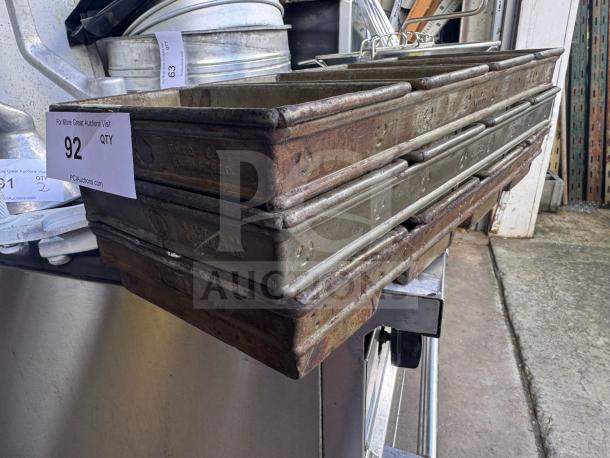 Lot of 3 vintage Ekco E-81 baking pans, used condition with visible wear, marked with "Ekco" and "E-81" on sides.