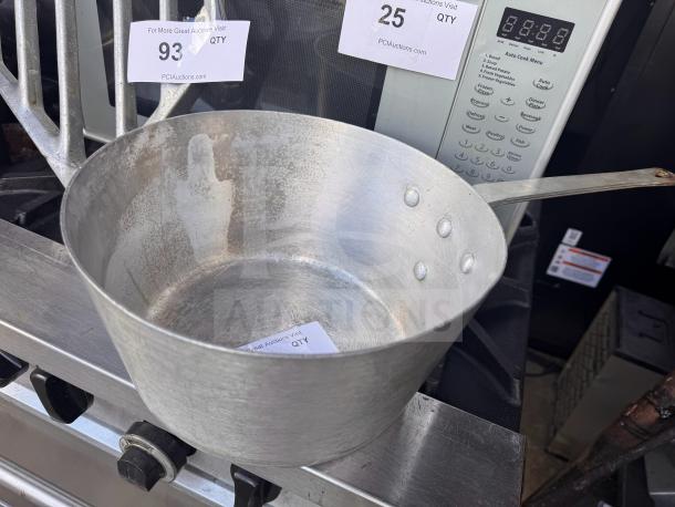 Aluminum sauce pan with riveted handle, used condition. Auction tags indicate item number and quantity.