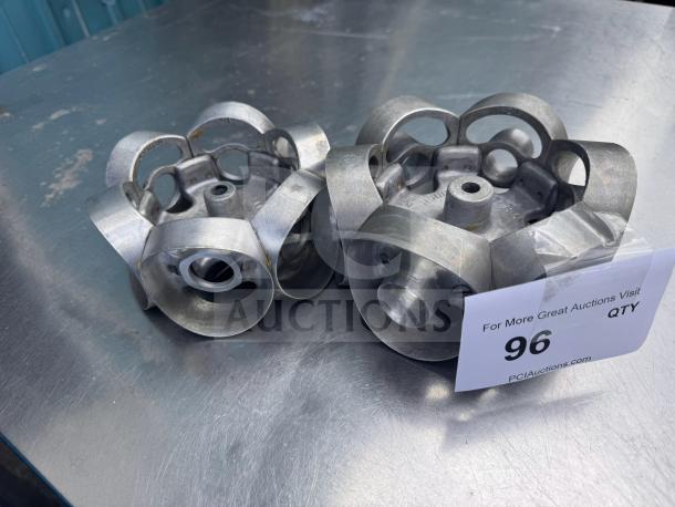 Metal revolving donut cutter mold, used condition, features sturdy metal construction. Auction tag number 96 visible.