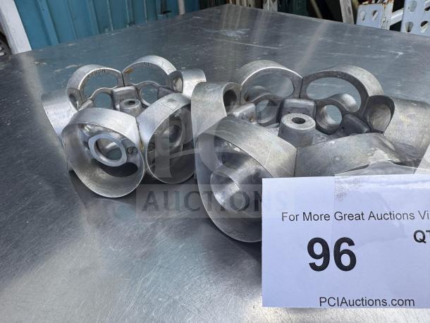 Metal revolving donut cutter machine mold for pastries, shown on a metal surface. Includes item number 96 label.