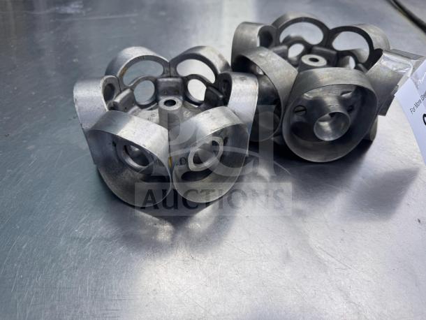 Metal revolving donut cutter maker, industrial-grade, used condition, visible metal wear, suitable for pastry production.