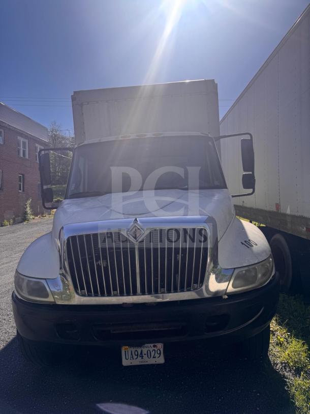 Box truck with a large cargo area, white exterior, visible front grill, license plate "UA94-029," and in used condition.