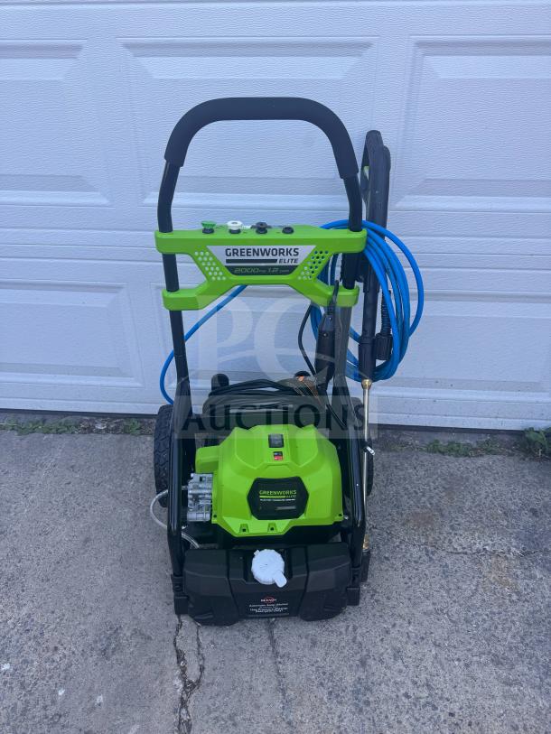 Brand new Greenworks Elite 2000 PSI electric pressure washer with blue hose and ergonomic handle.