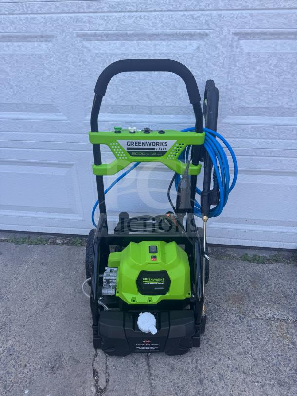 Greenworks Elite 2000 PSI Electric Pressure Washer, brand new. Features green design, hose, gun, and model label.