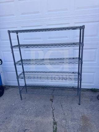 5-tier steel wire shelving unit with adjustable shelves, in good condition. Shown against a white garage door.