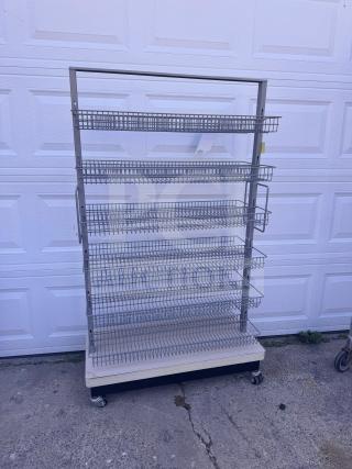 Mobile wire basket shelving unit with multiple tiers, caster wheels for mobility, in good condition. Ideal for display use.