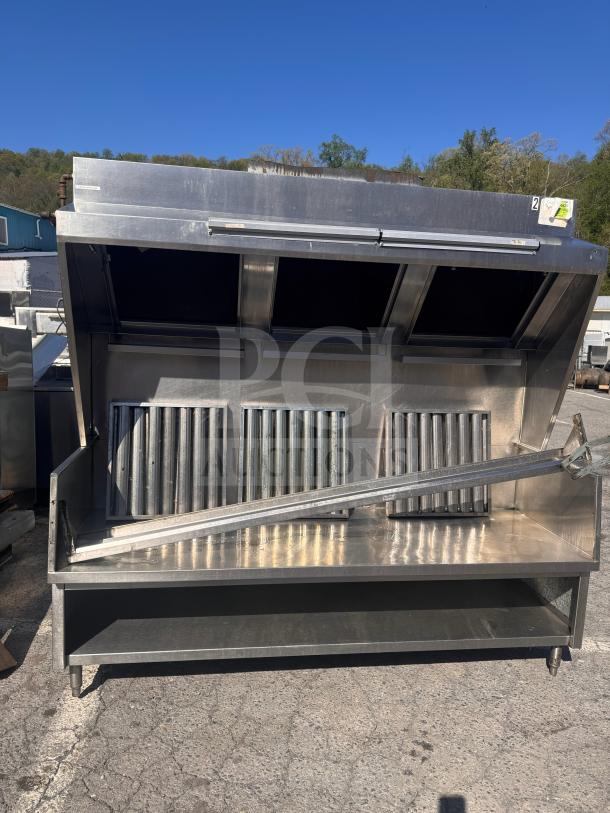 Stainless steel 6 1/2 low profile commercial exhaust hood, ideal for food trucks, with grease filters and open underside.