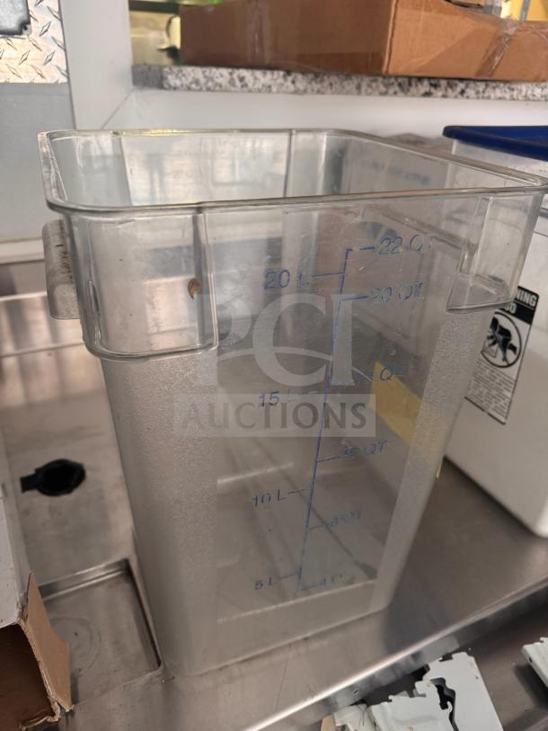 Clear 22qt storage food container with measurement markings in quarts and liters, good condition.