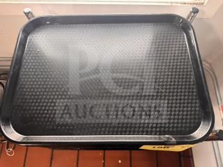 Black food tray with textured surface, rectangular shape, used condition, visible corner chip.