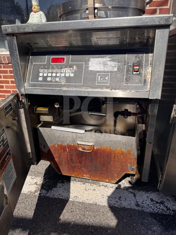 BKI FKM-FC commercial electric pressure fryer, 208 volts, stainless steel, visible rust and wear, control panel with buttons.