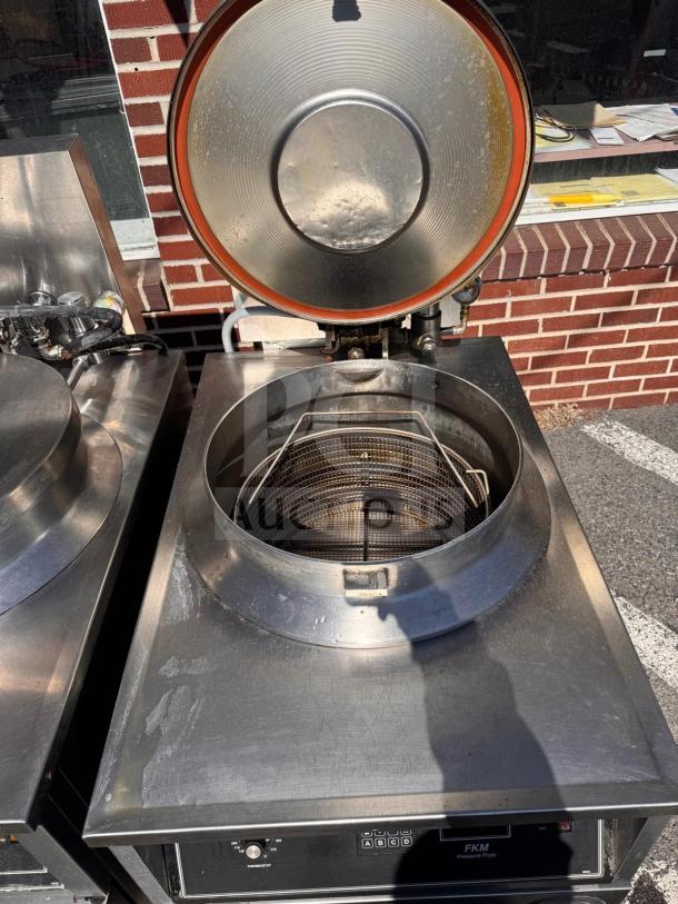 BKI FKM-FC commercial electric pressure fryer, open lid, stainless steel, 208 volts, visible control panel, used condition.