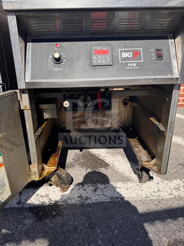 BKI FKM-FC commercial electric pressure fryer, 208 volts, showing control panel and casters, in used condition.